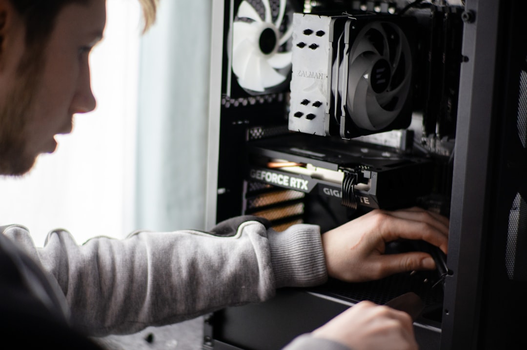 a-man-is-working-on-a-computer-in-a-room-hgurxw2lmxq